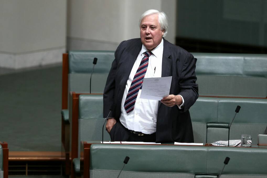 Palmer United Party leader Clive Palmer puts a question to Prime Minister Tony Abbott during question time in Federal Parliament. Photo: Alex Ellinghausen