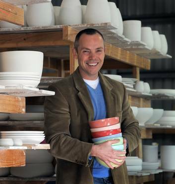 Brian Tunks of Bison Australia, at his factory/showroom in Pialligo, holding tulip bowls. Photo: Graham Tidy