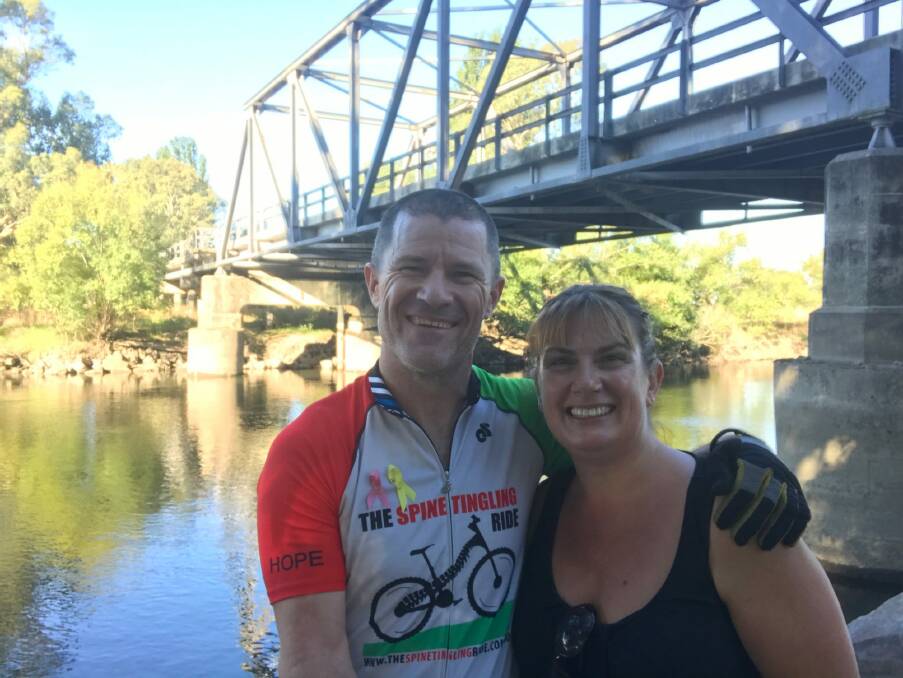Andrew and Jodie Kerec this week during their epic fundraising bike trip from Canberra to the outskirts of Darwin. Andrew is riding off-road and Jodie is accompanying him in a support vehicle. Photo: Supplied
