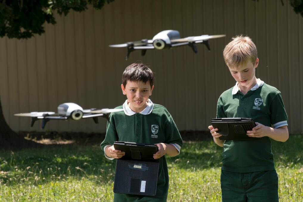 Mitcham Primary School students Jack and Aidan have been programming drones as part of the school's innovative STEM program. Photo: Eddie Jim