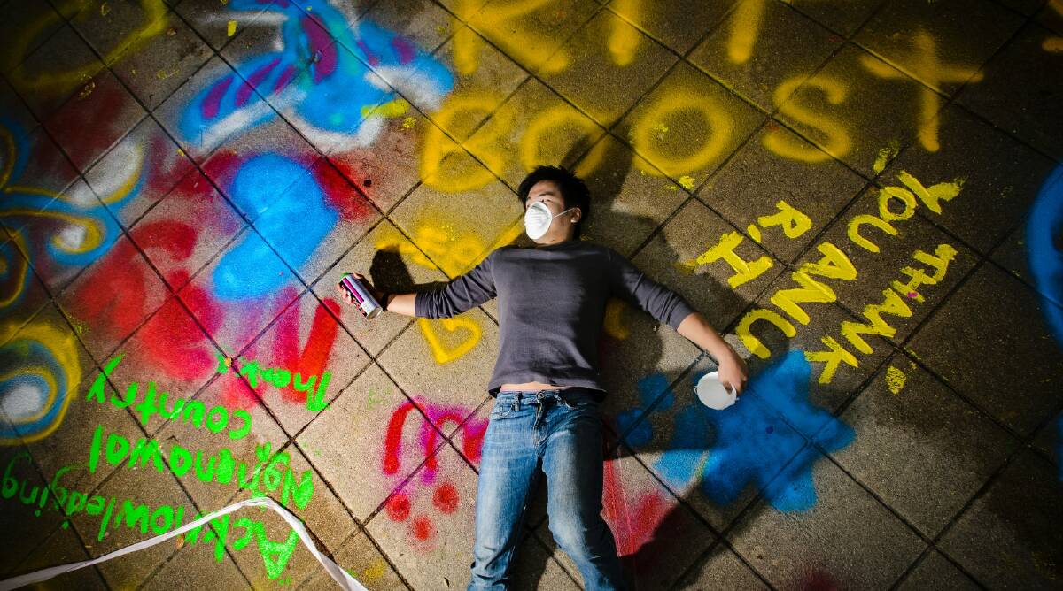 Dozens of ANU students seized an opportunity to spray paint messages on the university's Union Court before being closed off for demolition. Photo: Sitthixay Ditthavong