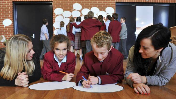 Anti-bullying presenters, Rosie Thomas, left and her sister, Lucy, with year 5 students, Alice Humphries, 10, of Weetangerra and Spencer Burns, 11, of Hawker. Photo: Graham Tidy