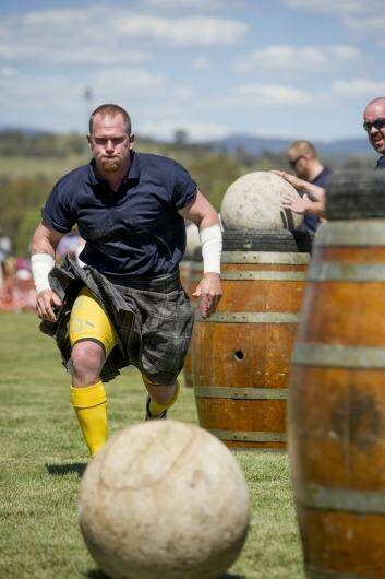 Focused: Strongman Moe Westmoreland moves in for the challenge during the Stones of Manhood competition at the Canberra Highland Gathering & Scottish Fair in Kambah. Photo: Jay Cronan