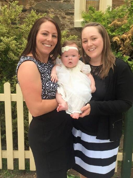 Emma Fowler, of Bonython, with her "very special niece'' Ruby Wigg, and her sister Kate Wigg, of Jerrabomberra. Ruby is biologically Kate's child; Emma carried Ruby for her sister. Photo: Supplied