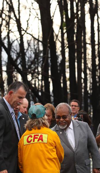 Sir Michael Somare meets  firefighters  at Kinglake yesterday. Photo: Ken Irwin 