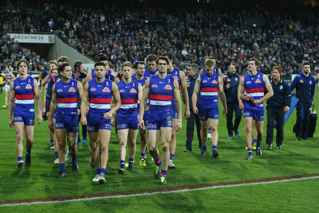 The dejected Bulldogs leave the ground after the loss to Geelong. Photo: Getty Images