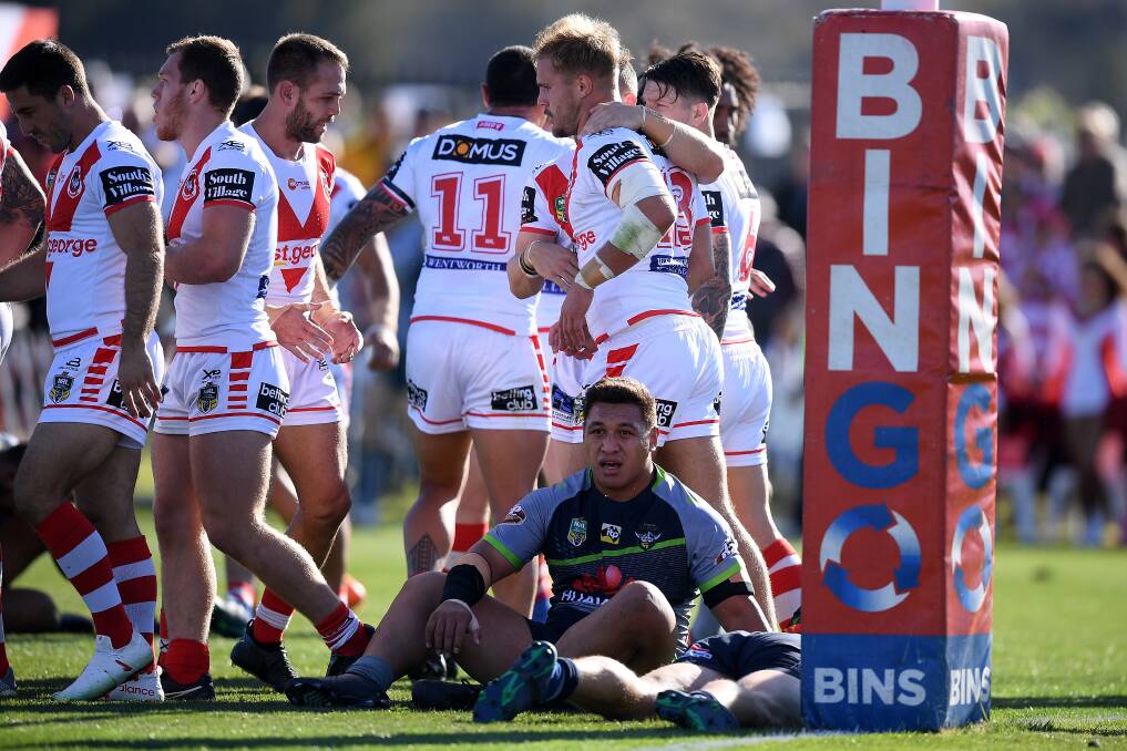 Josh Papalii looks forlorn as the Dragons celebrate a try.