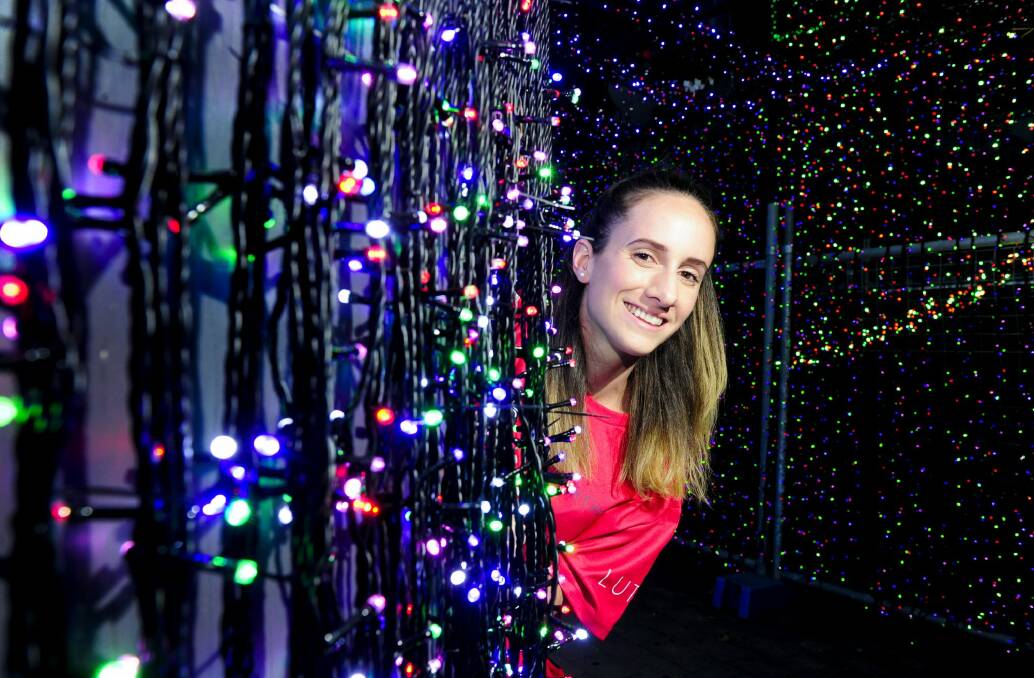 Gabrielle Weider from Sids and Kids surrounded by Christmas lights. Photo: Melissa Adams