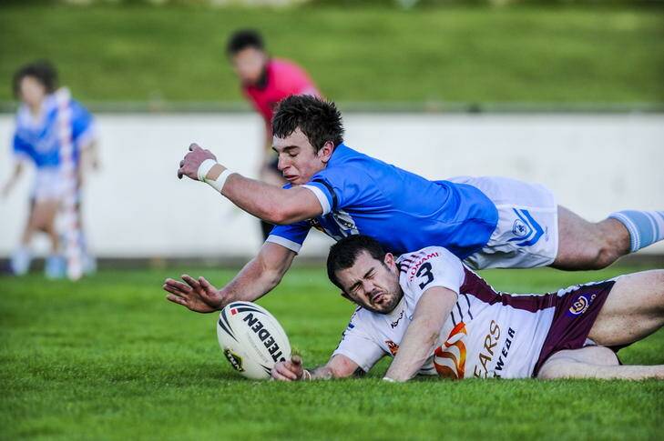 Kangaroos player Matt Adam and Blue Tyson Endacott dive for the ball during yesterday's local derby. Photo: ROHAN THOMSON