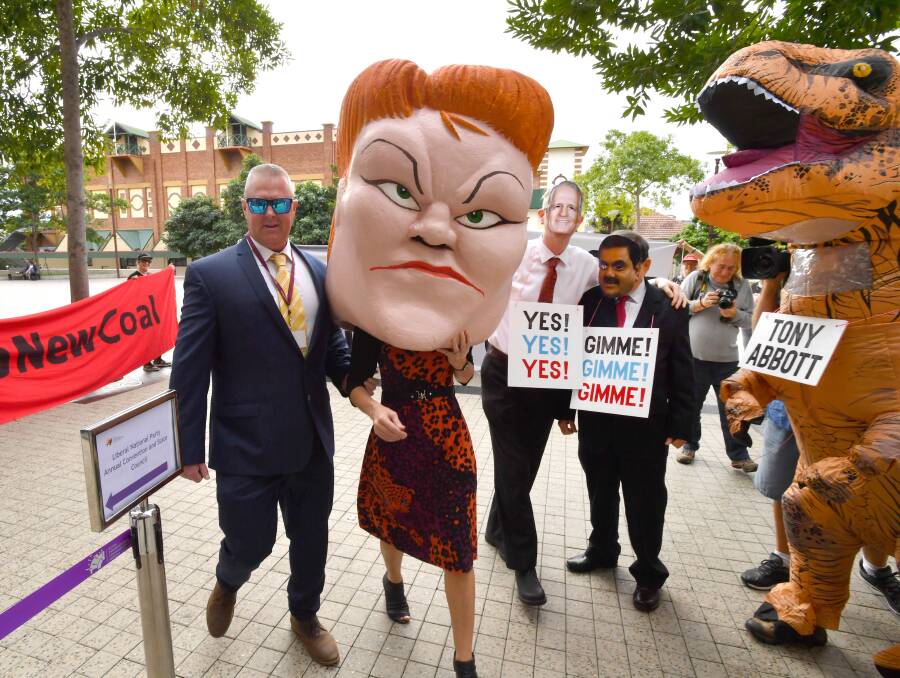 Protestors wearing masks depicting One Nation leader Pauline Hanson, Prime Minister Malcolm Turnbull and Gautam Adani with a person in a dinosaur costume depicting former Prime Minister Tony Abbott Photo: Darren England - AAP