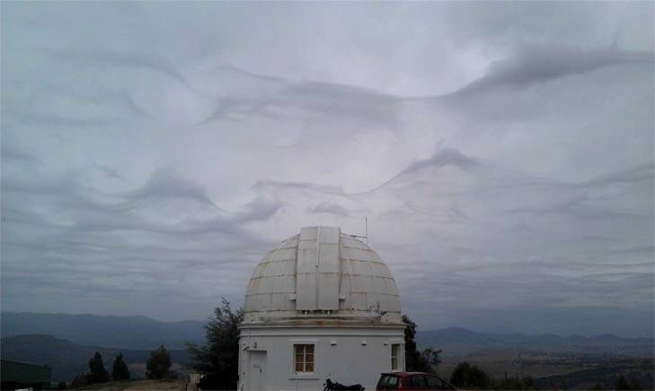 A strange combination of clouds gathering over Mt Stromlo gave the sky an eerie feel yesterday. Photo: Chris Nolan