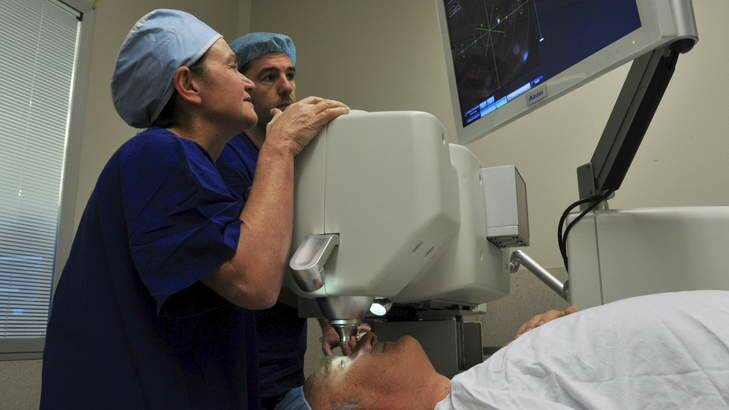 Eye surgeon Dr Kerrie Meades, left, and technician Olivier Fourcot, with a patient. Photo: Graham Tidy
