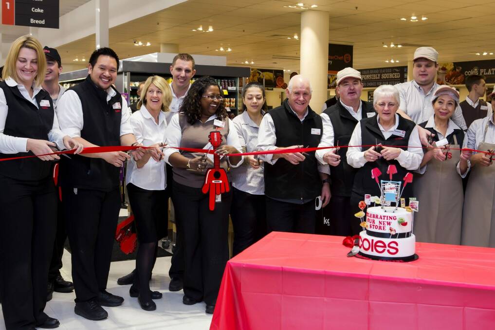 Staff cut the ribbon at the opening of the new Coles at the Canberra Centre on Wednesday. Photo: Supplied