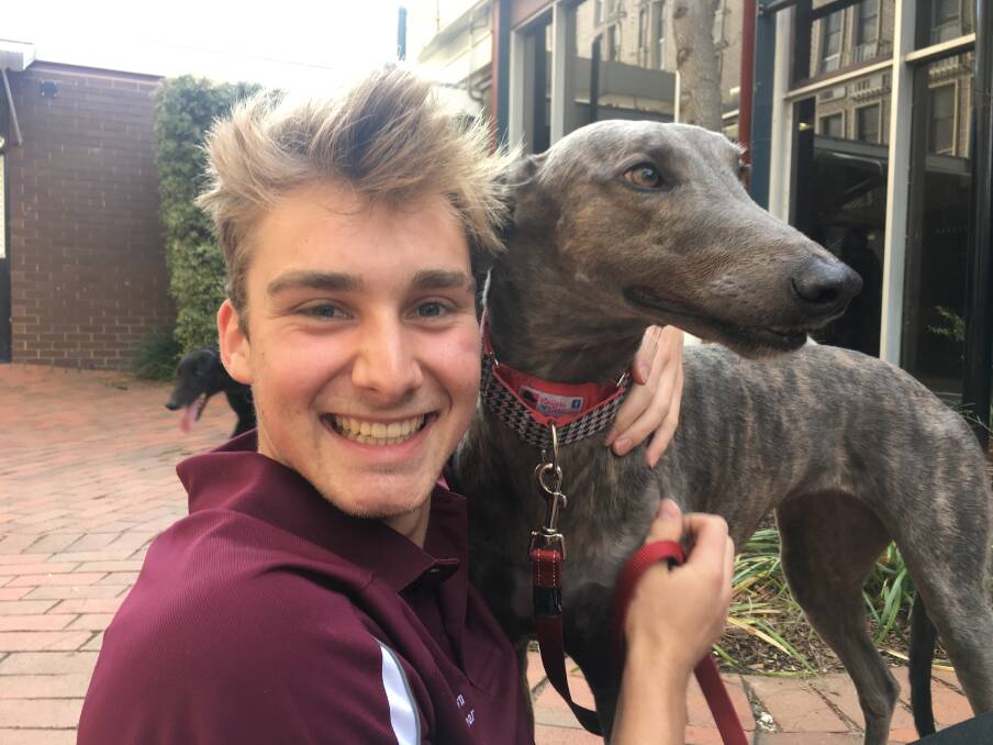 Student Chris Brown with a greyhound on Sunday. Photo: Alexandra Back