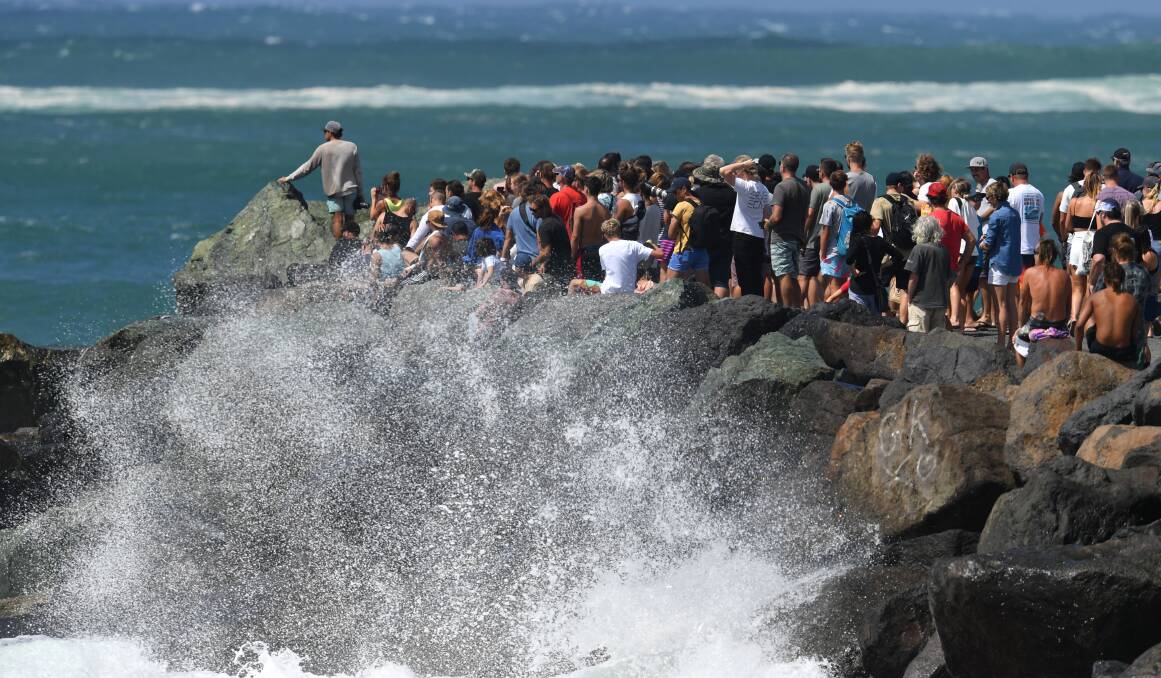 Crowds of people watching the waves at Kirra on the Gold Coast on Saturday. Photo: AAP Image/ Darren England