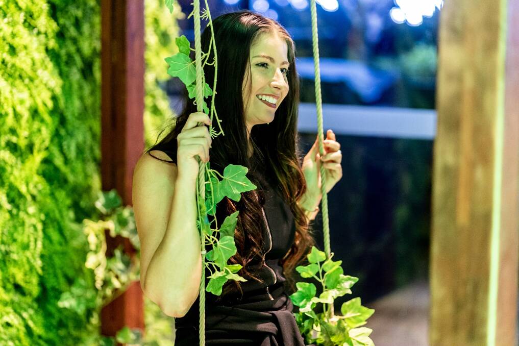Every real estate launch needs a swing. A guest enjoying the Envie launch by Geocon. Photo: Supplied