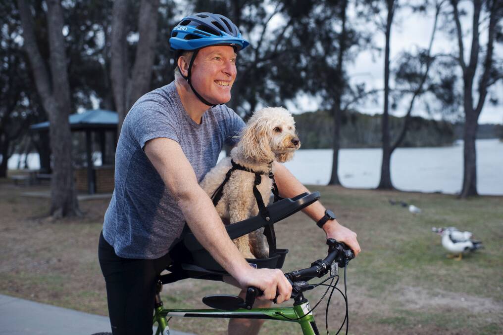 The Steele family take their dog Archie on cycling trips using the Buddy Rider seat. Photo: Christopher Pearce