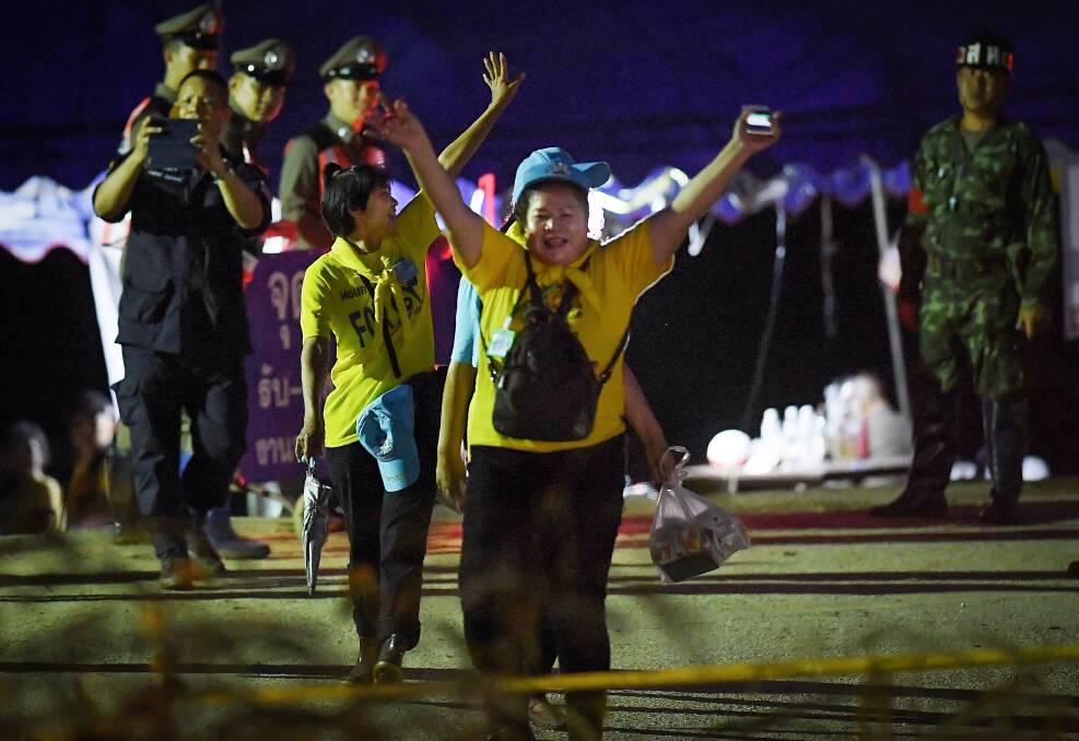 Thai volunteers cheer as they return from Tham Luang cave after the group was rescued.  Photo:  Kate Geraghty