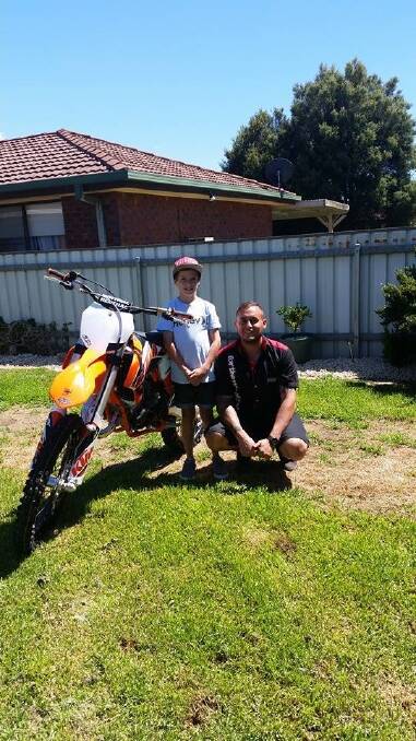 Canberra Motorcycle Centre's Brendon Bassett helps grant Nicholas Antone's wish of owning his dream motorbike.