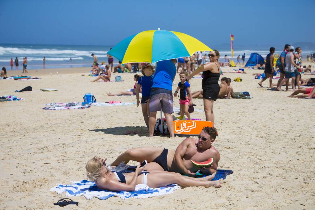 Swimmers and sunbakers bask in hot weather on the Gold Coast beaches. Photo: Glenn Hunt