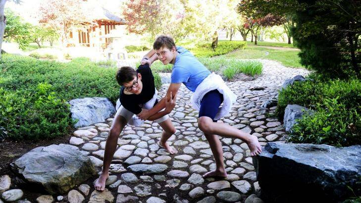 In a bind: Sumo wrestlers Oscar Skrbinsek,13 and Matt Duncan,12 both of Forrest at the Canberra Nara Peace Park. Photo: Melissa Adams