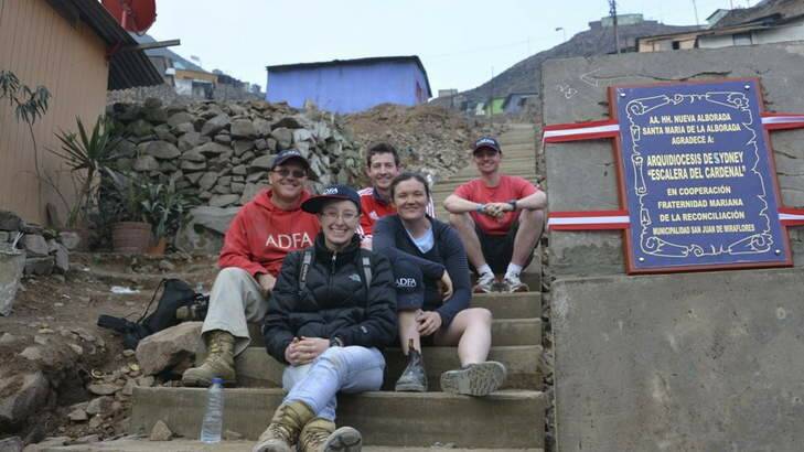 Chaplain Anthony Doyle, left, Rachael Cuddihy, Gordon Hutcheon, Sarah Moriarty and Justin Comfort on the steps they built in the slum neighbourhood of Pamplona Alta in Lima, Peru. Photo: Supplied