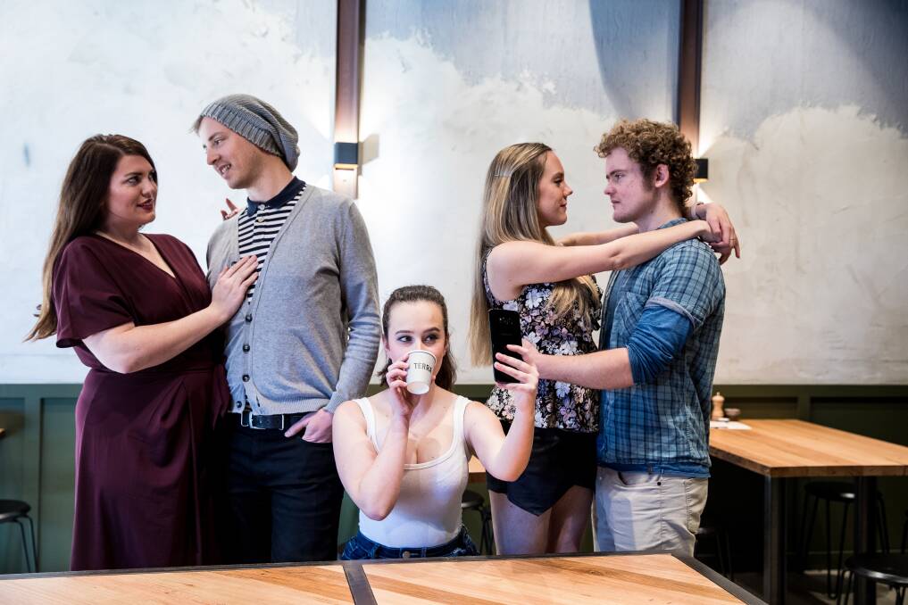<i>Cosi fan tutte</i>: Left to right- Fiordiligi (Keren Dalzell) and Fernando (Andrew Barrow) are together with Dorabella (Clare Hedley) and Guglieilmo (Nathanael Patterson) on the right while Despina (Katrina Wiseman) busies  herself on her phone and drinking coffee on the job. Photo: Supplied