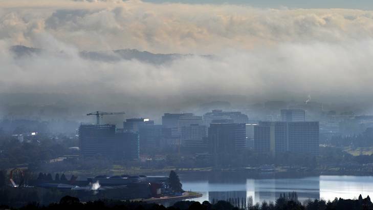 Morning fog lingers over the hills surrounding the city on Sunday. Picture taken from Red Hill lookout. Photo: Graham Tidy