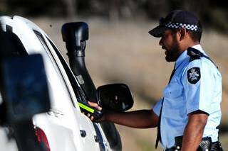 Constable Kele Nabukete stops a vehicle for a random breath test.