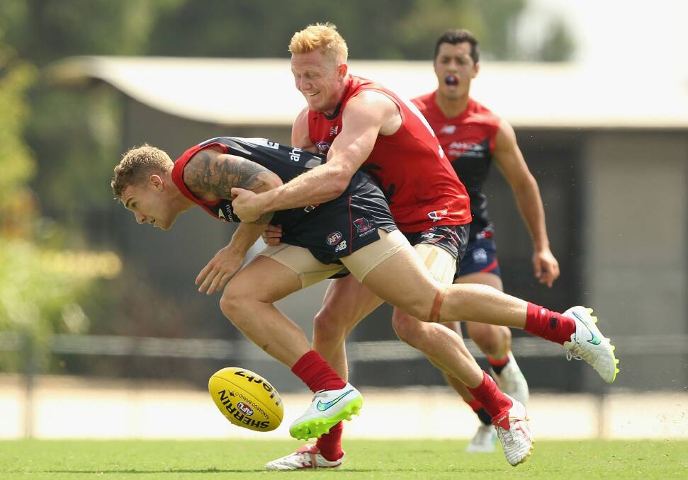 Holding on: The Demons' Dean Kent is tackled at the AFL Intra-Club match at Casey Fields on Thursday. Photo: Getty Images