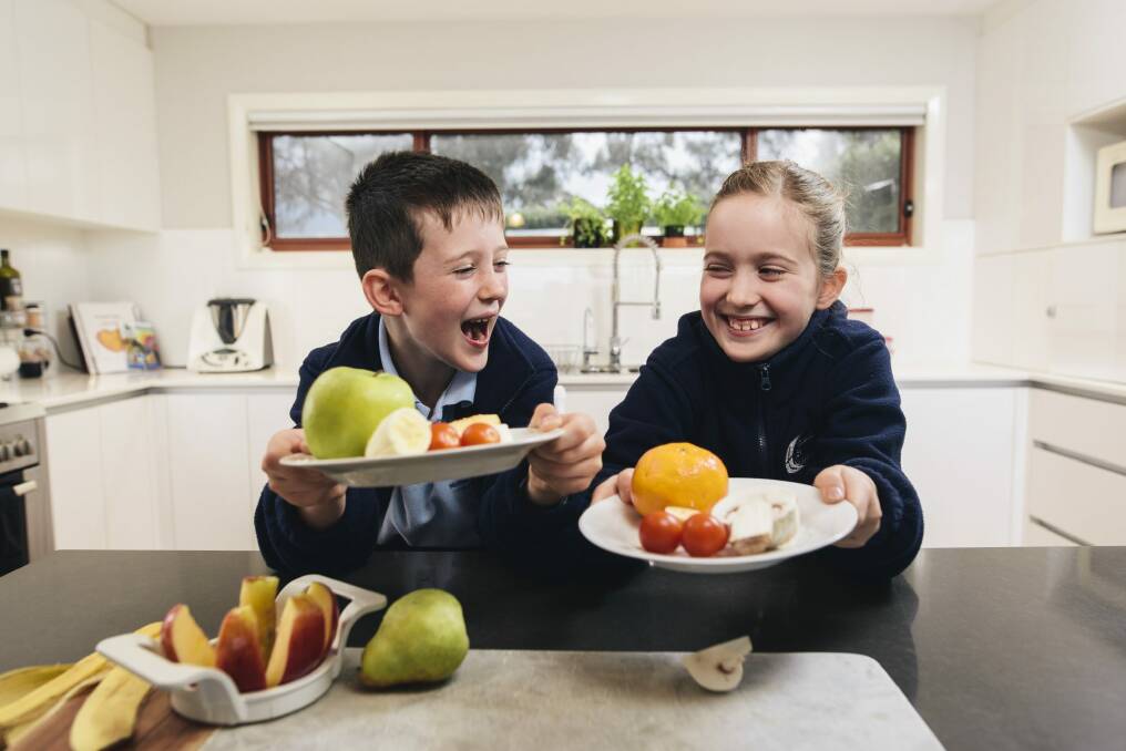 Lucas and Emily Olive enjoy their healthy afternoon tea of fruit rather than sugar-packed snacks. Photo: Rohan Thomson