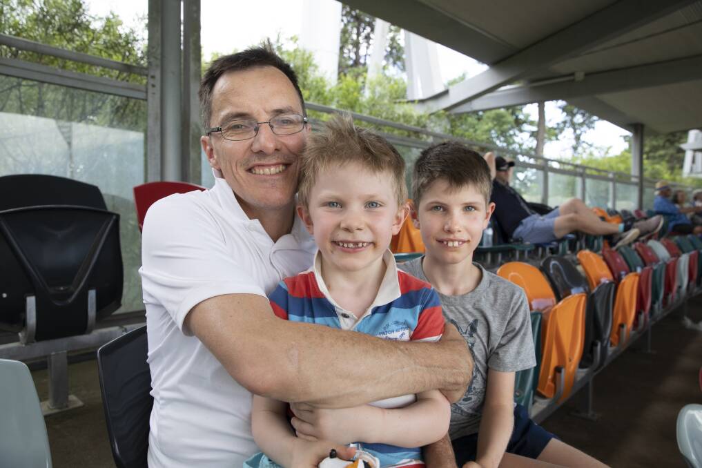 Stuart Richardson from Cook with his sons Darcy, 6, and Hugo, 9, enjoying day four of the Test match between Australia and Sri Lanka. Photo: Sitthixay Ditthavong