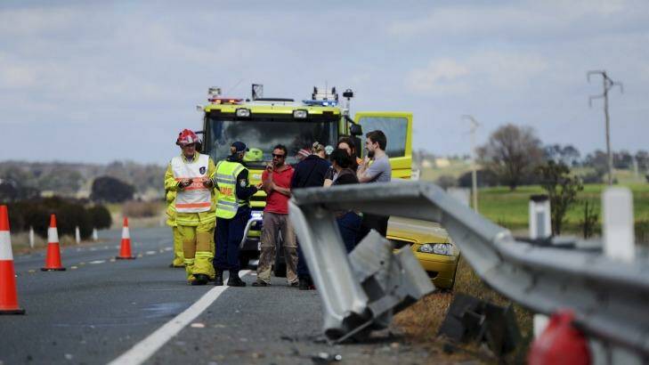 Emergency personnel attend the crash scene on Barton Highway on Saturday. Photo: Graham Tidy