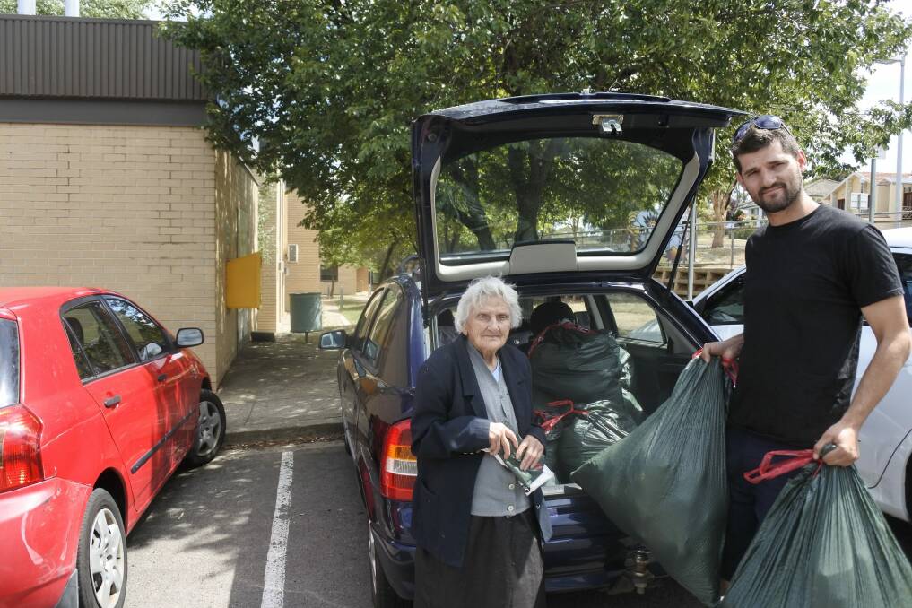 Stasia and Joshua delivering food and treats to clients at Canberra's methadone clinic on Thursday with Johusa's 2001 Holden Astra. Photo: Megan Doherty