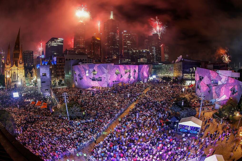 The midnight fireworks display, seen from Federation Square, lights up the city skyline during the New Year's Eve celebrations. Photo: Daniel Pockett
