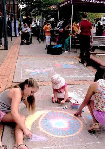Family time: Chalk drawing at the Parties at the Shops event at Wanniassa. Photo: Megan Doherty