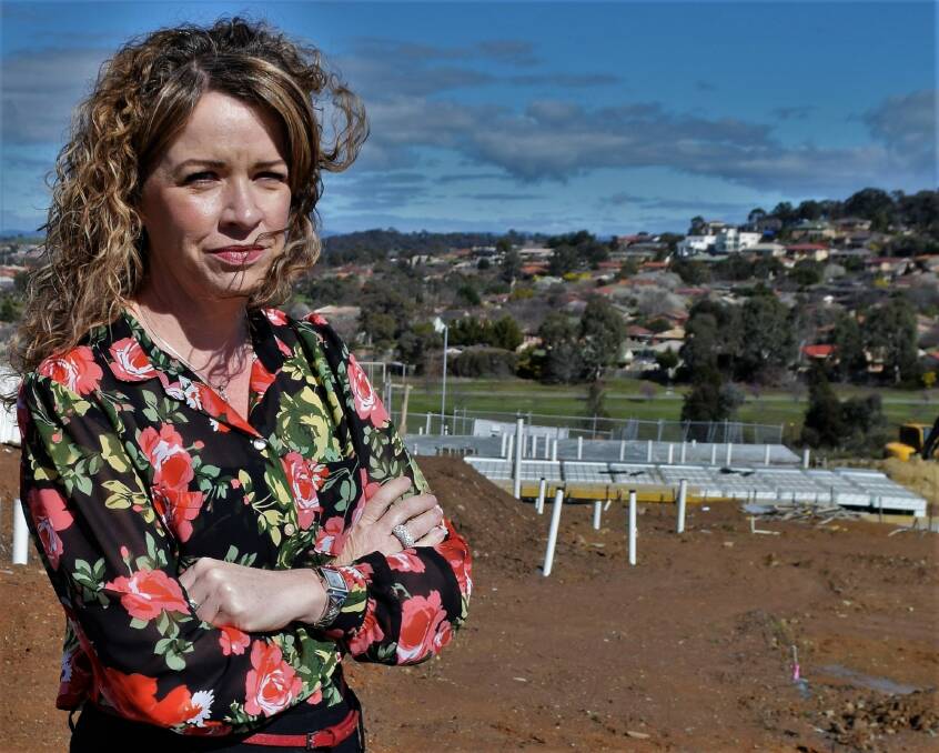 Kerrianne Abbott at the site of her new home in the Canberra suburb of Moncrieff. Ms Abbott said the delay between her purchase of the block more than a year ago and final permission to build was unacceptable. Photo: David Ellery