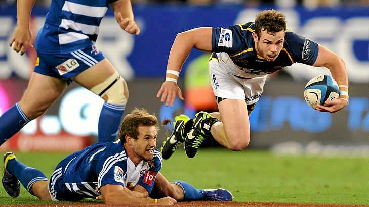 Robbie Coleman of the Brumbies skips over the tackle by Nick Groom of the Stormers. Photo: Getty Images