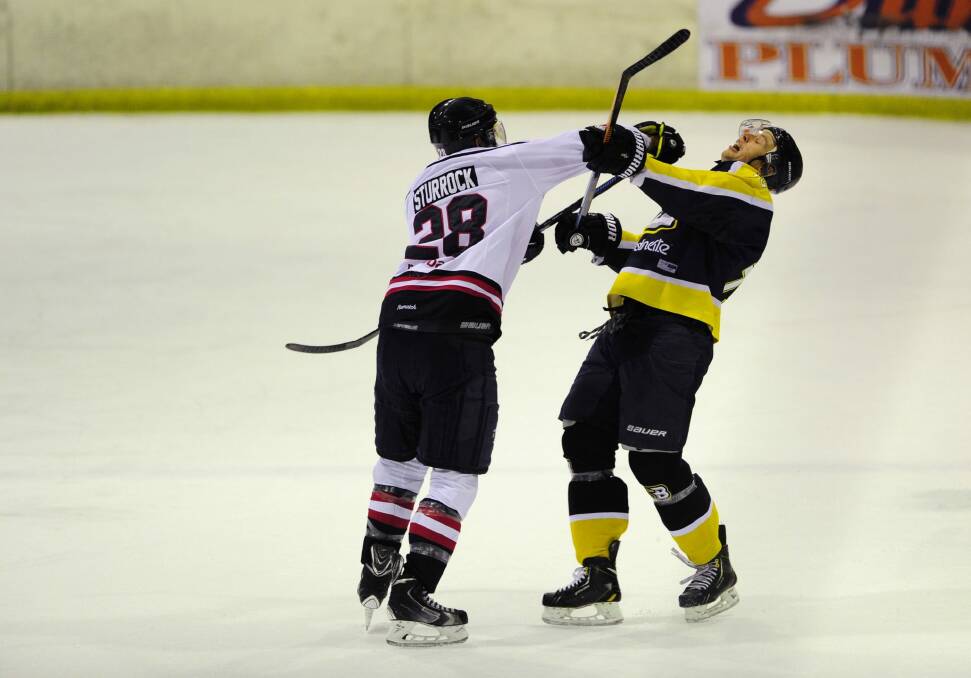 Melbourne Ice's Greg Sturrock and Stephen Blunden of the Canberra Brave get involved in a scuffle in Sunday night's game.  Photo: Melissa Adams 