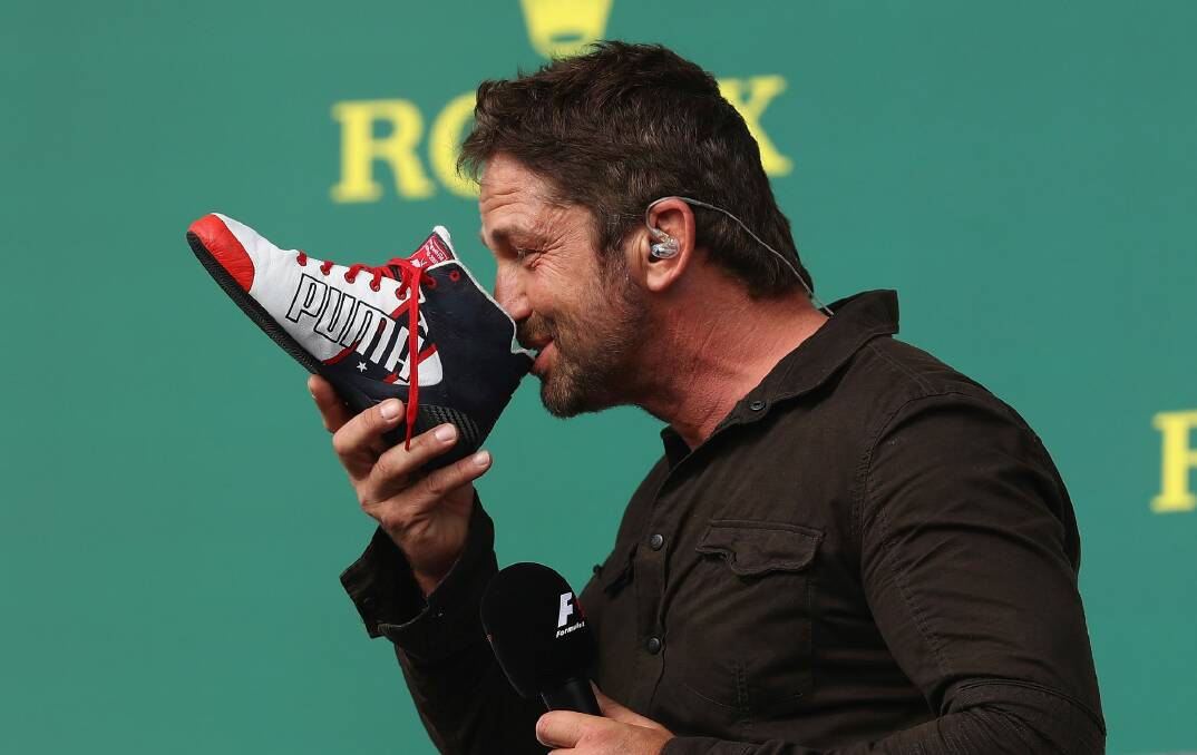  Actor Gerard Butler even did a shoey on the podium with Daniel Ricciardo in the US. Photo: Getty Images