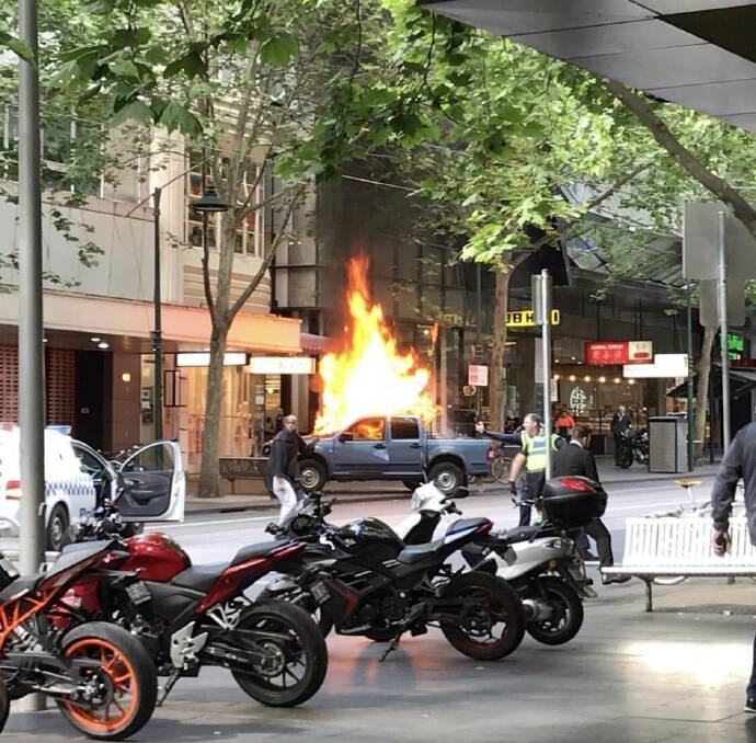 The blazing vehicle on Bourke Street. Photo: Supplied