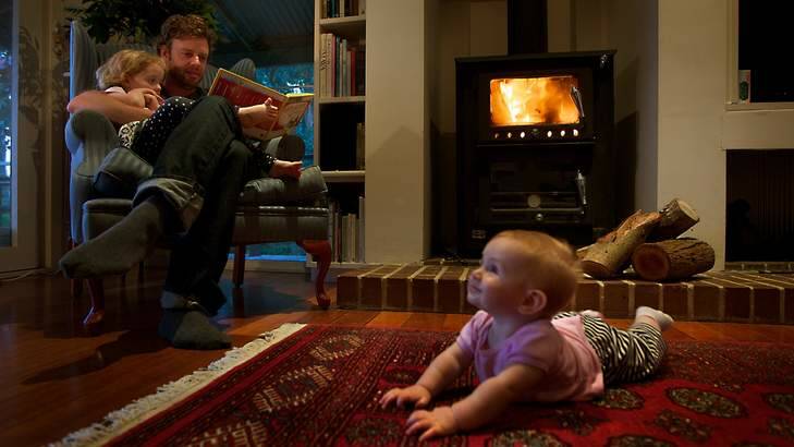 David Glen and his children at home in front of the fire. Photo: Simon O'Dwyer