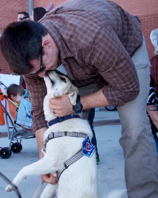Eric Yarger is reunited in the US in 2014 with  Snickle Fritz. A US charity, Puppy Rescue Mission, fundraised to cover the cost of getting the dog out of Afghanistan, which included an 800km taxi trip as well as plane rides. Photo: Supplied