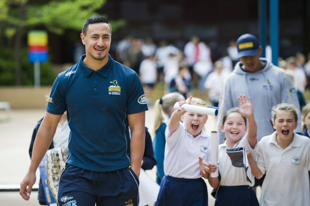 Brumbies and Vikings outside back Lausii Taliauli with excited year 5 students Emily Bermingham, Mailee King and Amelia Robinson at 
the Jerrabomberra Public School on Tuesday morning.  Photo: Rohan Thomson