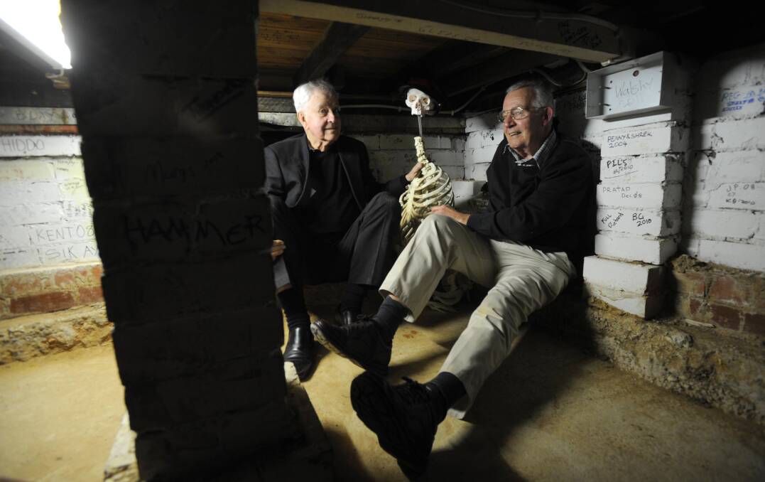 Ross Thomas, left, and Peter Anderson share a yarn with a skeleton in the ‘room within a room’. Photo: Graham Tidy