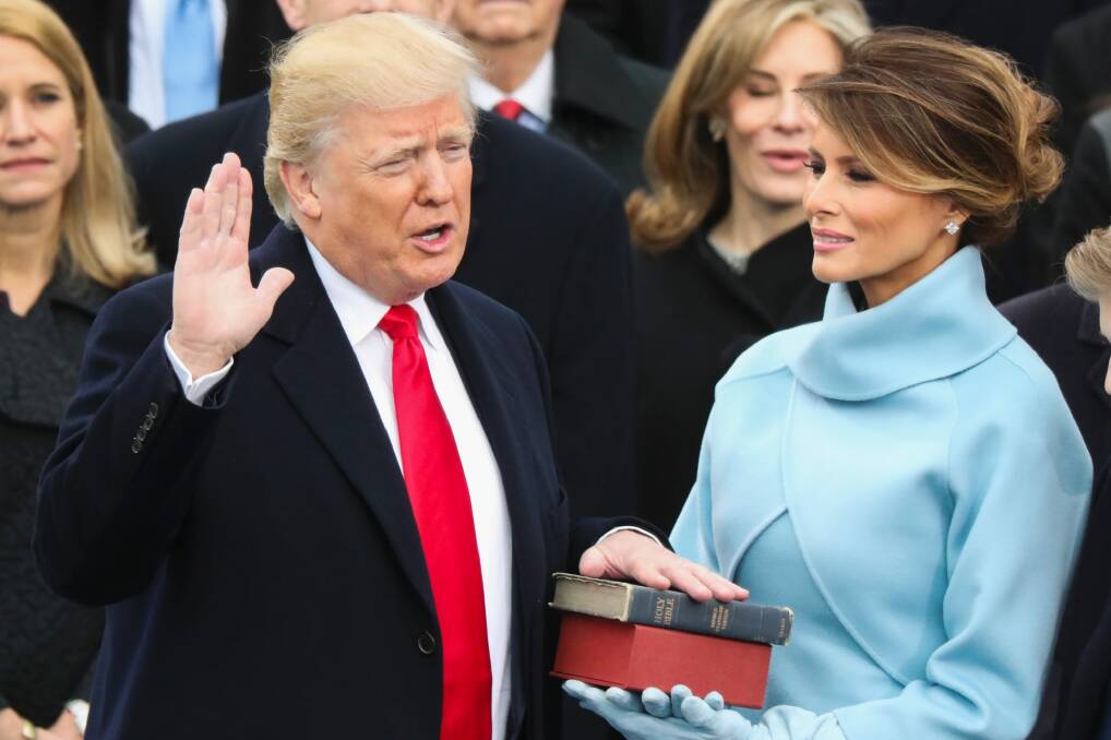 Donald Trump, watched by his wife Melania, is sworn in as the 45th president of the United States. Photo: Andrew Harnik