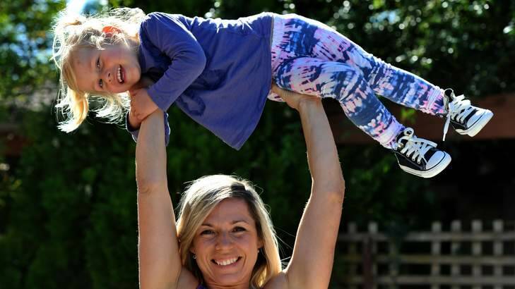 Power lifter Liz Craven at her Kambah home with her 2-year-old daughter, Abigail. Photo: Graham Tidy