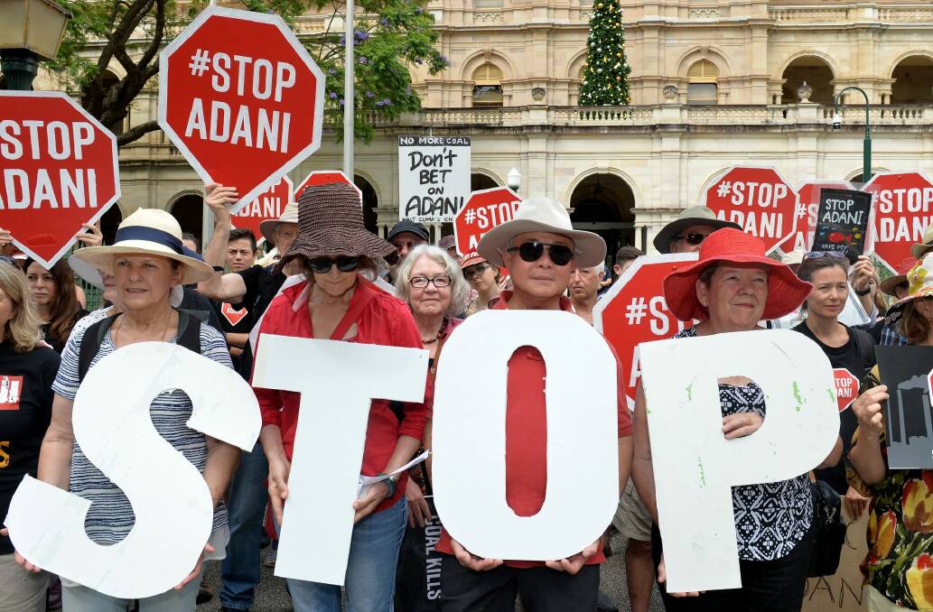 Adani protestors are seen protesting outside of Queensland's Parliament House in Brisbane. Photo: AAP