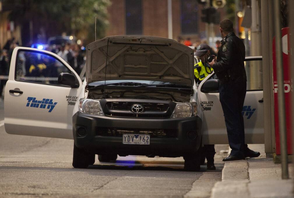 Police check a ute of a man who made a threat on Phillip Street in Sydney.  Photo: Shu Yeung