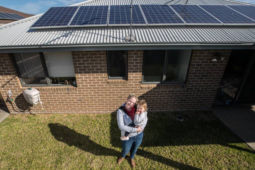 Gemma Cook, with daughter Mia, says the Andrews government's solar pitch is enticing. Photo: Jason South
